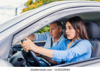 Woman Driver - Car Accident, Yells In Fear Or Frustration. Student Girl Sitting Scared In A Car. Incident Happens. Car Crash Accident With A Scared Driver And A Instructor