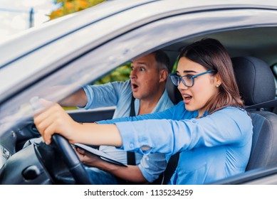 Woman Driver - Car Accident, Yells In Fear Or Frustration. Student Girl Sitting Scared In A Car. Incident Happens. Car Crash Accident With A Scared Driver And A Instructor