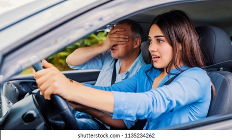 Woman Driver - Car Accident, Yells In Fear Or Frustration. Student Girl Sitting Scared In A Car. Incident Happens. Car Crash Accident With A Scared Driver And A Instructor