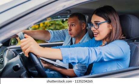 Woman Driver - Car Accident, Yells In Fear Or Frustration. Student Girl Sitting Scared In A Car. Incident Happens. Car Crash Accident With A Scared Driver And A Instructor