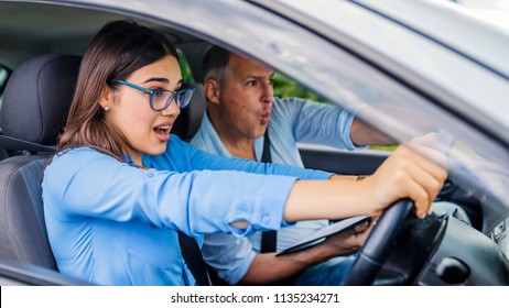 Woman Driver - Car Accident, Yells In Fear Or Frustration. Student Girl Sitting Scared In A Car. Incident Happens. Car Crash Accident With A Scared Driver And A Instructor