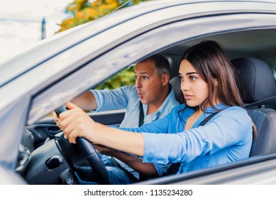 Woman Driver - Car Accident, Yells In Fear Or Frustration. Student Girl Sitting Scared In A Car. Incident Happens. Car Crash Accident With A Scared Driver And A Instructor