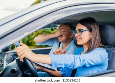 Woman Driver - Car Accident, Yells In Fear Or Frustration. Student Girl Sitting Scared In A Car. Incident Happens. Car Crash Accident With A Scared Driver And A Instructor