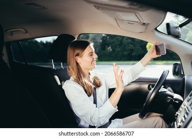 Woman Driver In The Car Businesswoman Well Dressed Talking On A Video Call Of A Mobile Phone In The Parking Lot