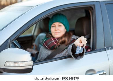 Woman A Driver Making Cashless Payment Via Credit Card Inside Of Her Car, Looking At Camera