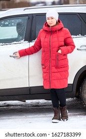 Woman A Driver Opening Dooor Of Her Minivan, Full Length Portrait, Dressed Red Down Jacket