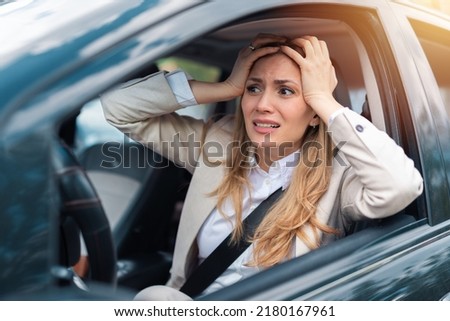 Woman driver scared shocked before crash or accident hands out of wheel on road