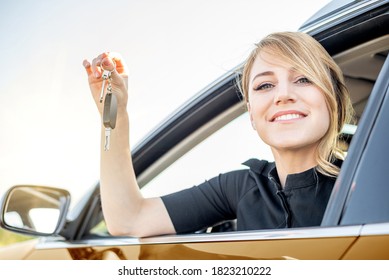 The Woman Driver Shows The Key To The Car. Car Purchase Or Rental.