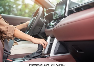 woman driver stick shift transmission a car gear, hand controlling steering wheel during vehicle moving. Journey, trip and safety Transportation concepts - Shutterstock ID 2217734857