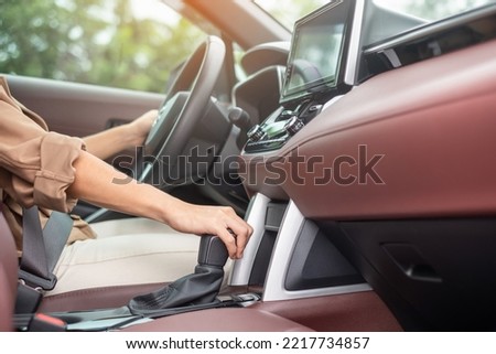 woman driver stick shift transmission a car gear, hand controlling steering wheel during vehicle moving. Journey, trip and safety Transportation concepts