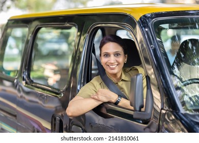 Woman Driver In Uniform Driving A Taxi
