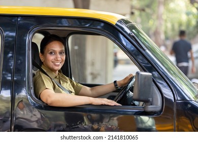 Woman Driver In Uniform Driving A Taxi
