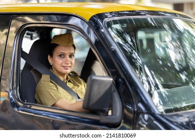 Woman Driver In Uniform Driving A Taxi
