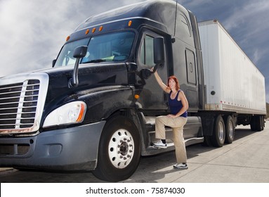 Woman Driver At The Wheel Of Her Commercial 18-wheeler Diesel Semi Truck.