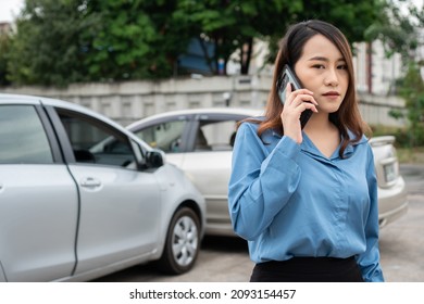 Woman Drivers Call Insurance After A Car Accident Before Taking Pictures And Sending Insurance. Online Car Accident Insurance Claim Idea After Submitting Photos And Evidence To An Insurance Company.