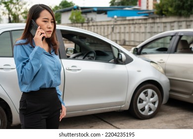 Woman Drivers Call Insurance After A Car Accident Before Taking Pictures And Sending Insurance. Online Car Accident Insurance Claim Idea After Submitting Photos And Evidence To An Insurance Company.