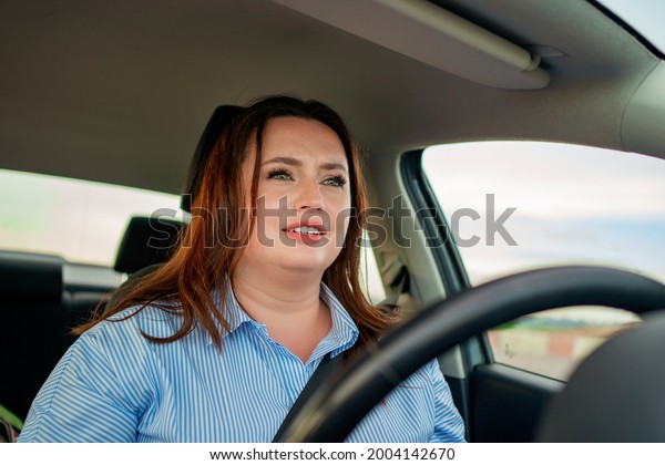 A woman drives a car. travelling around\
the city. businesswoman. stress on the road. daily trips to the\
office and university. school\
driving