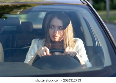 Woman drives her car for the first time, tries to avoid a car accident, is very nervous and scared, worries, clings tightly to the wheel. Inexperienced driver in stress and confusion after an accident - Shutterstock ID 2026312733
