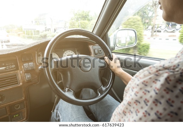 woman\
driving a car in the city with vintage shirt\
