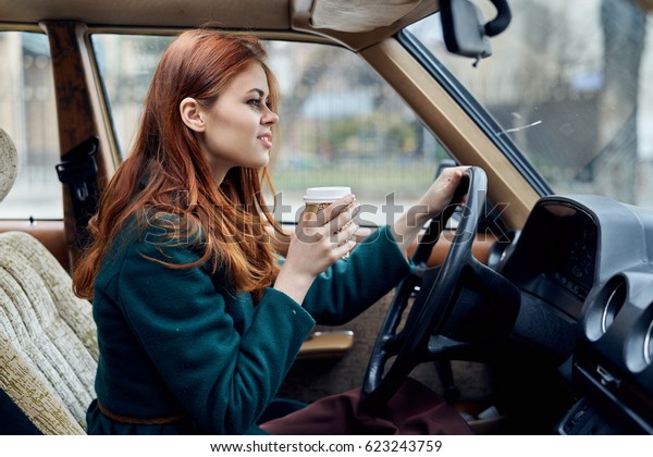                             Woman driving a car with a\
coffee   
