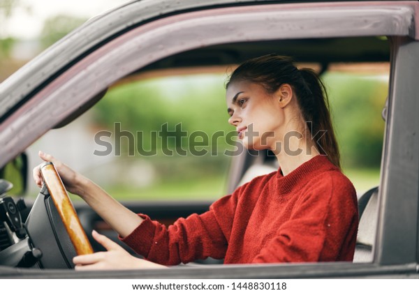 Woman driving a car driving countryside\
countryside nature\
transportation