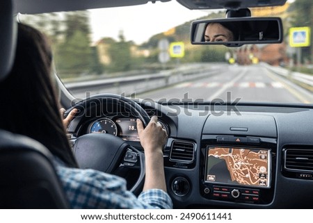 Similar – Image, Stock Photo woman driving in a car  through mountains closeup, blurred with focus on the mountain. Road trip and adventure.