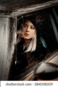 Woman Driving A Car In The Rain