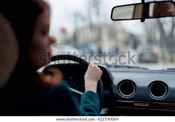            Woman driving a car rear view                
   