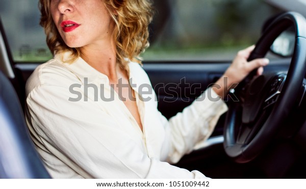 Woman driving a car in reverse\
