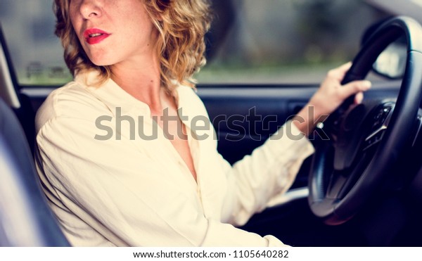 Woman driving a car in reverse\
