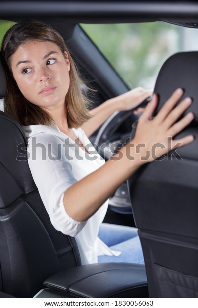 woman driving a car in\
reverse