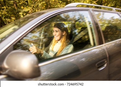 Woman Driving Car With Seatbelt And Smiling 