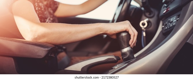 Woman driving a car and shifting gears on the gearbox. Concept of vacation and travel. - Shutterstock ID 2172380527