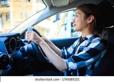 Woman driving a car and smiling