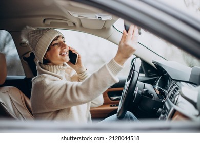 Woman Driving In Car And Using Phone