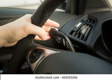 Woman Driving Car And Using Turn Signal Switch