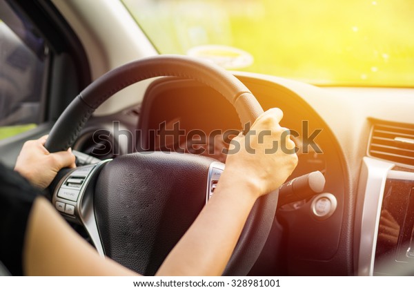 Woman driving car. Vintage\
filter