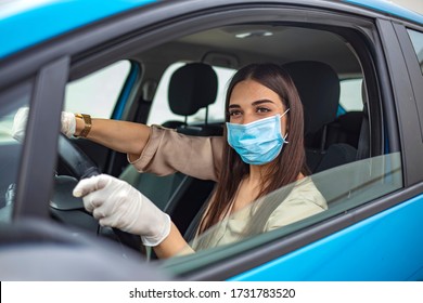 Woman driving car while wearing protective mask. Young woman protect her self from Corona virus wearing protective mask. Adult Woman Driving to Work Wearing Face Mask and Surgical Gloves During COVID - Powered by Shutterstock