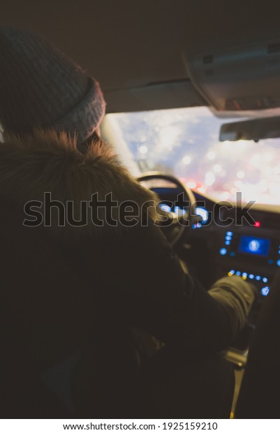 Woman driving a car in
winter time.