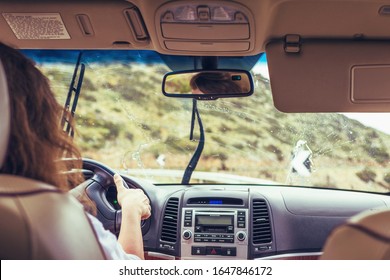 Woman Driving. Car Wipers Clean Windshield. Back View 