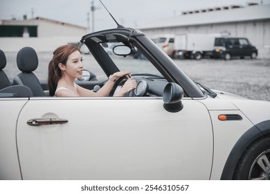 Woman driving in a convertible car.  - Powered by Shutterstock