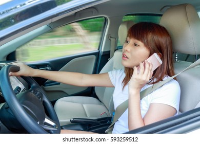 Woman Driving Fast A Car Distracted On The Phone And Looking On The Way.