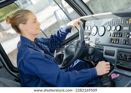 Woman driving heavy goods vehicle