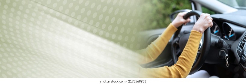 Woman Driving With Her Two Hands On Steering Wheel; Panoramic Banner