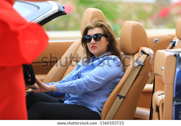 woman driving a\
limousine