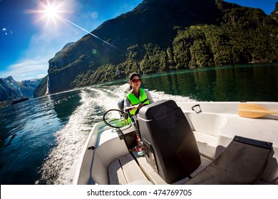 Woman Driving A Motor Boat. Geiranger Fjord, Beautiful Nature Norway.Summer Vacation.