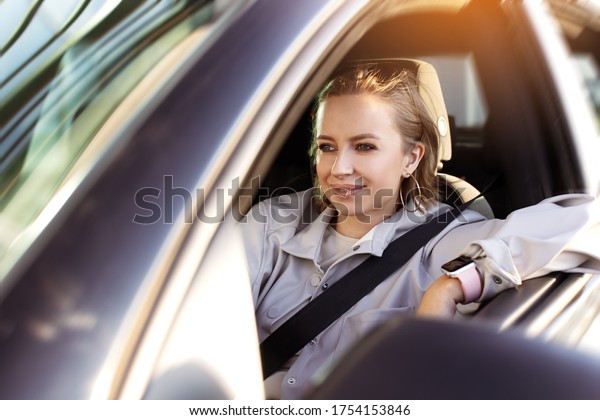 Woman driving on car holding\
steering wheel with open window, enjoy summer, freedom, weekend.\
Riding on road, enjoyment or driving, new driver learning to\
ride