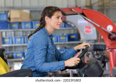 A Woman Driving A Tractor