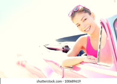 Woman Driving Vintage Retro Convertible Car In Pink. Retro Style Portrait Of Young Beautiful Happy Smiling Asian Woman Driver.