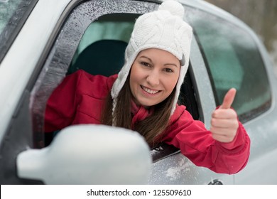 Woman Driving In Winter On Snow Covered Slippery Road In Forest